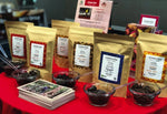 Conexion Chocolate's line of professional baking chocolate couverture with samples on a red table